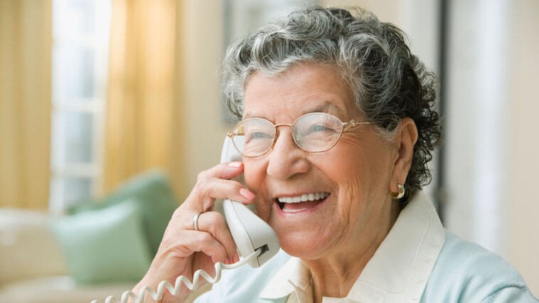Mature adult speaking on a telephone